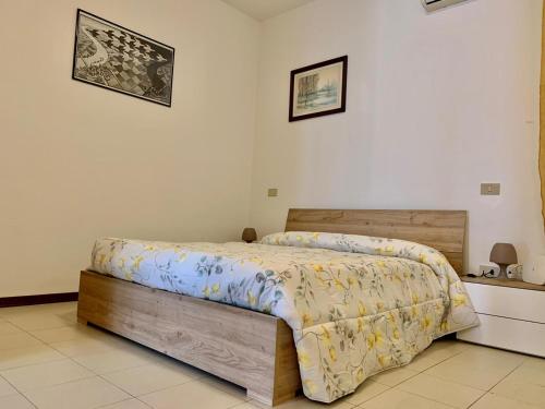 a bedroom with a bed with a wooden head board at Sweet Harmony in Lucca