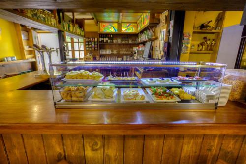 a display case filled with different types of pastries at Hostal Rural La Tintoreria in Villablino