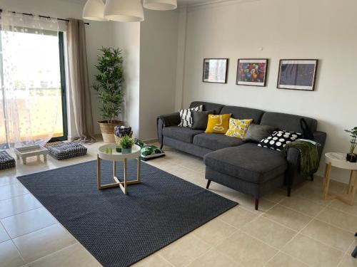 a living room with a couch and a table at OmniaX Apartment in Faro
