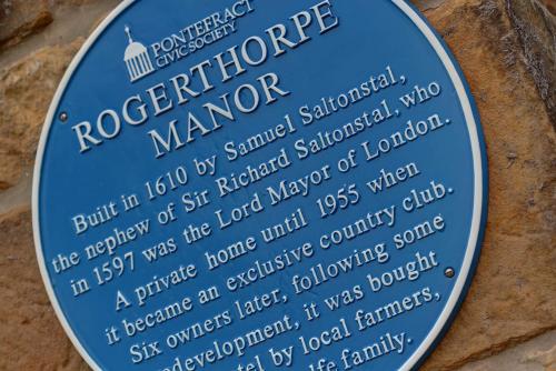 a sign on the side of a building at Rogerthorpe Manor Hotel in Pontefract