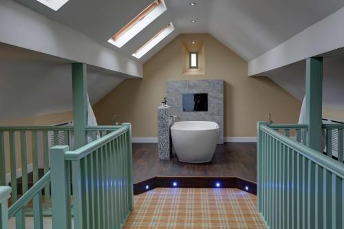 a bathroom with a bath tub in a room at Rogerthorpe Manor Hotel in Pontefract
