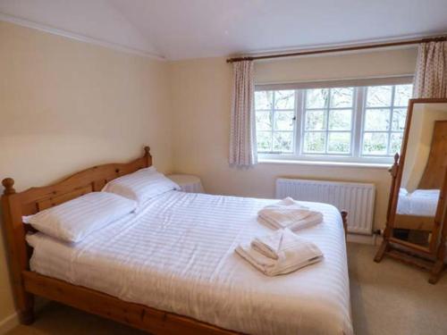 a bedroom with a bed with two towels on it at Littlebeck in Rosthwaite
