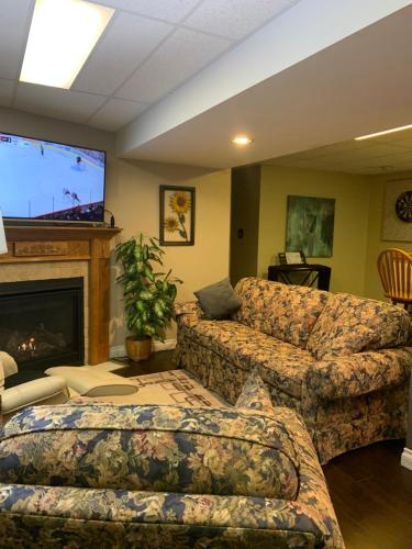 a living room with a couch and a flat screen tv at Evening Shade in Fergus