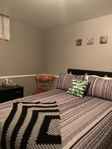 a bedroom with a bed with a couch and a chair at Evening Shade in Fergus