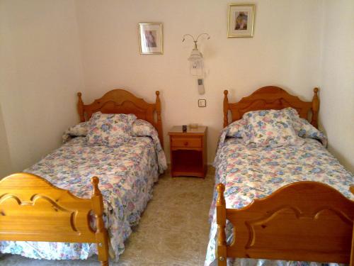 Posteľ alebo postele v izbe v ubytovaní Hostal Asensio Nijar