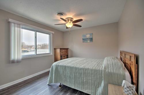 a bedroom with a bed and a ceiling fan at On-the-Water Retreat with Dock Pet Friendly! in Lake Ozark