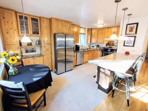 a kitchen with wooden cabinets and a table and a refrigerator at Nature Lovers Getaway in Flagstaff