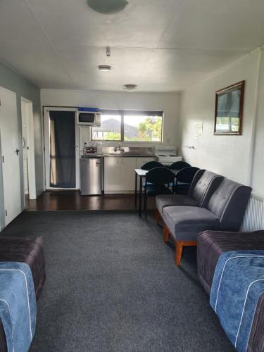 a living room with a couch and a table at Ohakune Court Motel in Ohakune