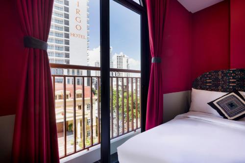 a bedroom with a bed and a large window at Heritage Boutique Sierra Legend in Nha Trang