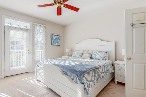 a bedroom with a white bed and a ceiling fan at Bear Trap Dunes --- 79C October Glory Ave in Ocean View