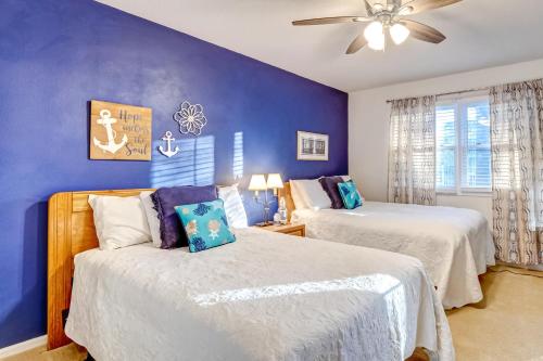 a bedroom with two beds and a ceiling fan at Club Villas 220-C in Sunset Beach