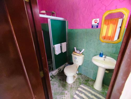 a bathroom with a toilet and a sink at Casa Del Merman at GayMontanita House in Montañita