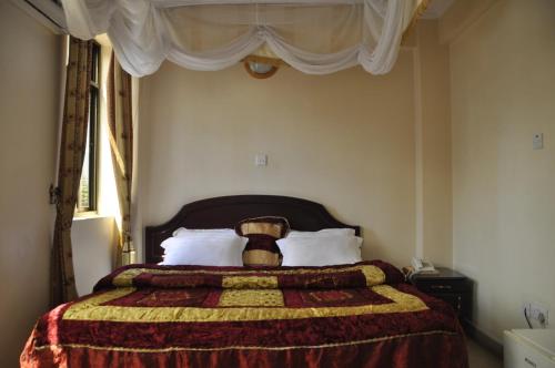 Ένα ή περισσότερα κρεβάτια σε δωμάτιο στο Rich Hotel