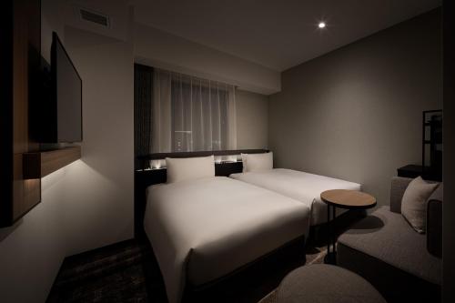 Una cama o camas en una habitación de Nest Hotel Naha Nishi