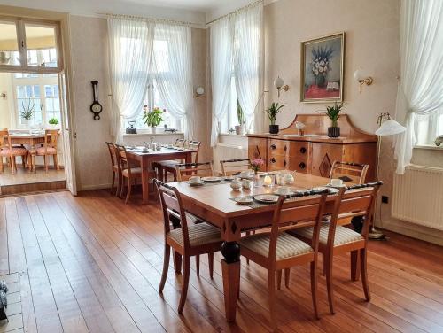 comedor con mesa de madera y sillas en Pension Jepsen, en Glücksburg