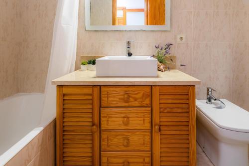a bathroom with a sink and a toilet and a tub at Angy Apartment in Alcudia