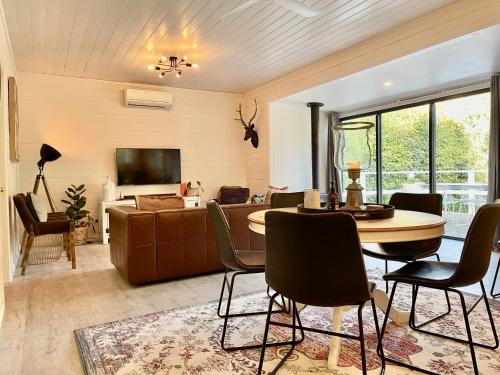 a living room with a table and chairs and a couch at Château Rosemund - ‘Your home away from home’. in Daylesford