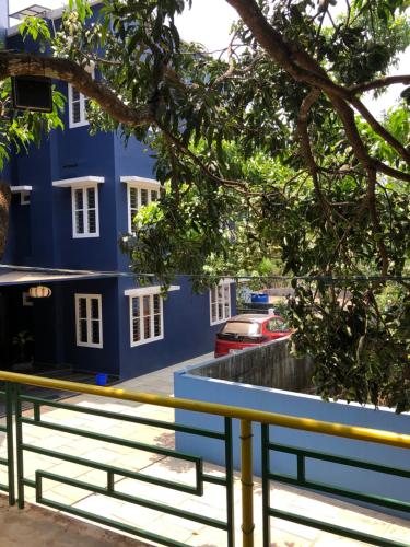 a blue building with a bench in front of it at Royal residency in Tindummal