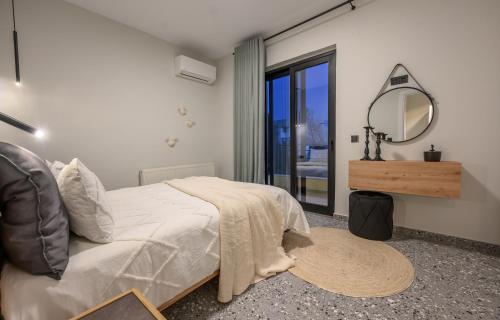 a bedroom with a large bed and a mirror at Niriides in Preveza