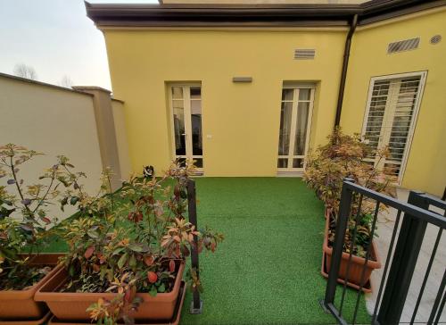 a balcony with potted plants and a house at BLhouse in Turin