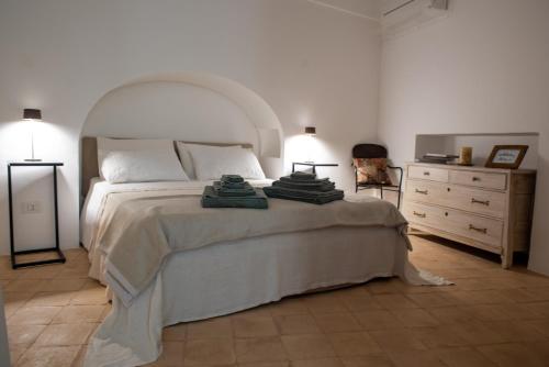 a bedroom with a large bed and a dresser at Dammuso Oltremare - Appartamento Lantana in Pantelleria