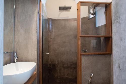 a bathroom with a shower with a sink and a toilet at Dammuso Oltremare - Appartamento Lantana in Pantelleria