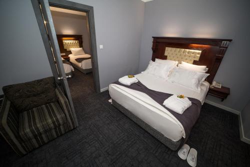 a bedroom with a large bed with white pillows at Funda Hotel in Trabzon