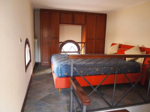 a bedroom with a bed with an orange bed frame at Alberico Gentili in Palermo