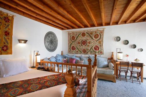 a bedroom with a bed and a couch at Melenos Art Boutique Hotel in Lindos