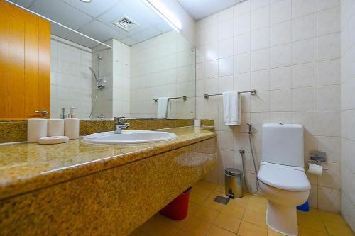a bathroom with a sink and a toilet at Discovery Gardens Studio near Ibn Battuta Mall & Metro - SAN in Dubai