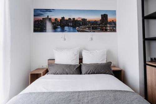 a bedroom with a bed with a city skyline at STEP INN The Fair Hotel in Rosbach vor der Höhe