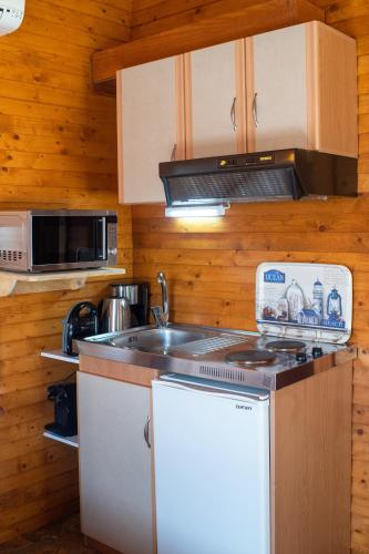 a kitchen with a sink and a stove at Aliki Guest House in Aígio