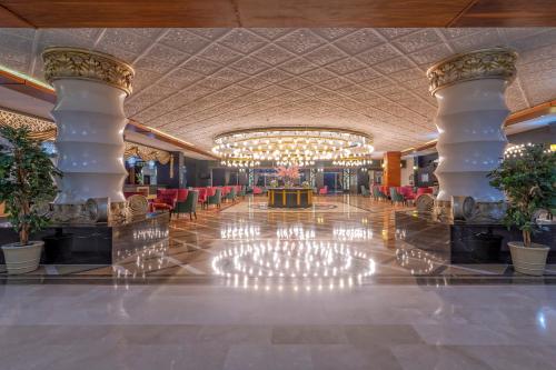 a lobby of a hotel with a chandelier at LRS Hotels Lake River Side Hotel & Spa - Ultra All Inclusive in Side