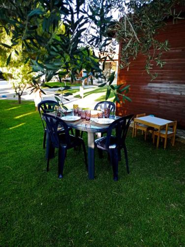 a table and chairs sitting on the grass at Aliki Guest House in Aígio