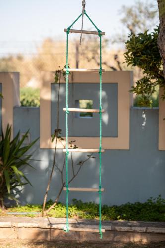 a green ladder with a plant on it at Aliki Guest House in Aígio