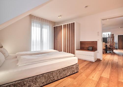 a bedroom with a large bed and a television at WaldFunkeln LODGE in Hinterzarten
