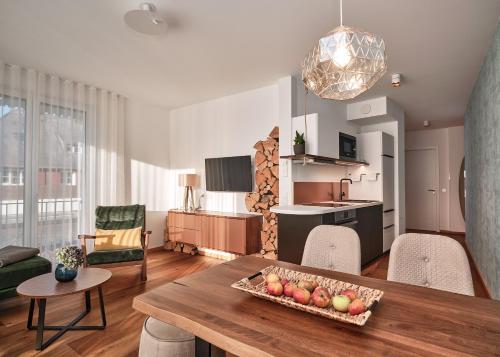 a living room with a table with a bowl of fruit on it at WaldFunkeln LODGE in Hinterzarten