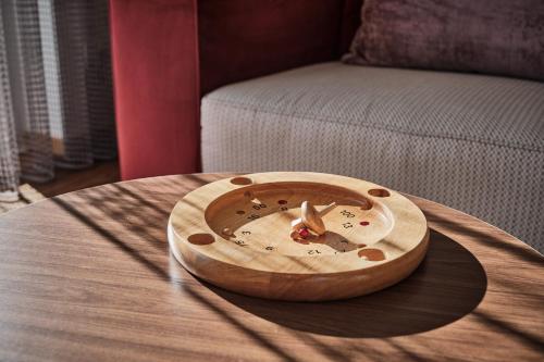 a wooden clock on top of a wooden table at WaldFunkeln LODGE in Hinterzarten