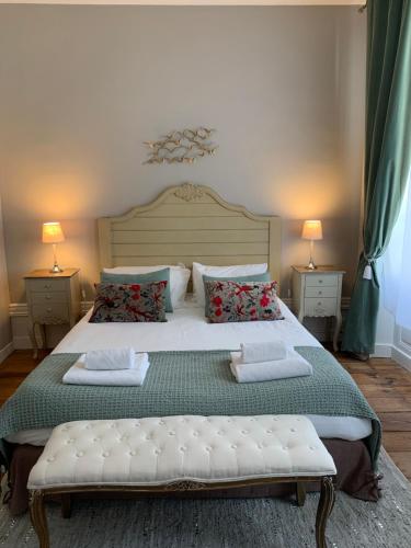 a bedroom with a large white bed with two lamps at Maison Charles Maurice in Chalais