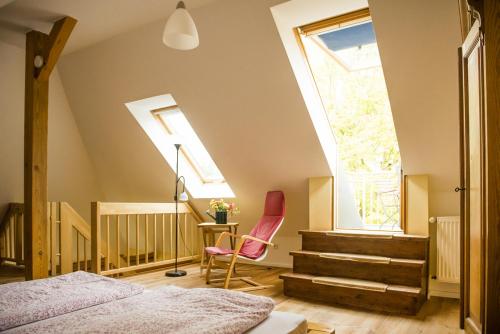 a bedroom with a bed and a window and a chair at Haus Seenland in Feldberg