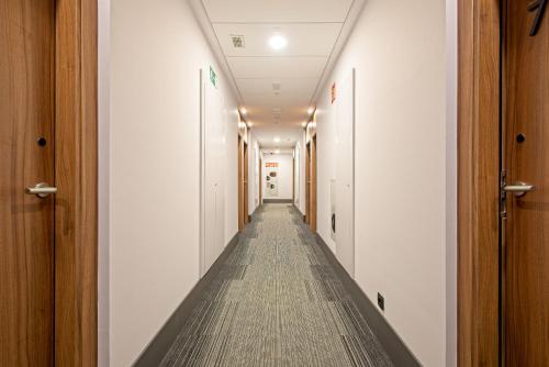 an empty corridor in a building with a long hallway at DWO Yuste Alcalá in Madrid