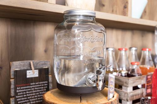 a glass jar filled with water on top of a table at GenussHotel Sonnblick in Sankt Leonhard im Pitztal