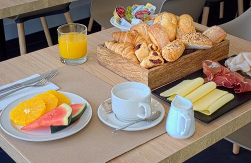 a table with a tray of bread and a tray of food at DWO Yuste Alcalá in Madrid