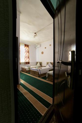 a view of a room with two beds at Sulaymon Guest House in Khiva