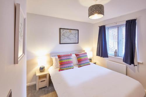 a bedroom with a white bed and a window at Host & Stay - Jet Cottage @ Spa Well in Whitby