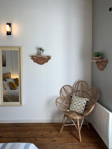 a room with a chair and a mirror at Maison Charles Maurice in Chalais