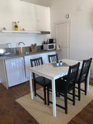 a kitchen with a table and chairs in a kitchen at Maison Charles Maurice in Chalais