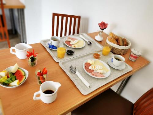 a table with breakfast foods and coffee on it at A.B. Hotel in Erlangen
