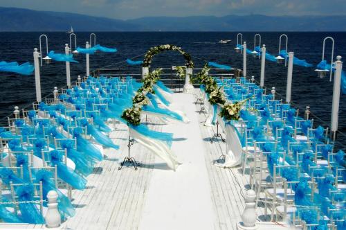 a line of blue chairs on a boat in the ocean at Montania Special Class Hotel in Mudanya