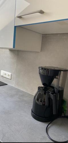 a coffee maker sitting on the floor under a counter at Ferienhaus Butterfly 2 in Garmisch-Partenkirchen